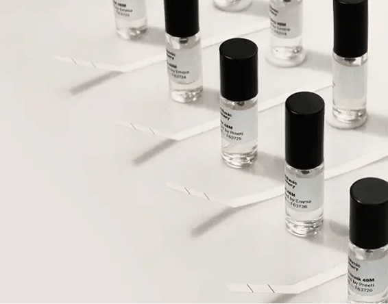 AI scent machine transferring small perfume bottle.