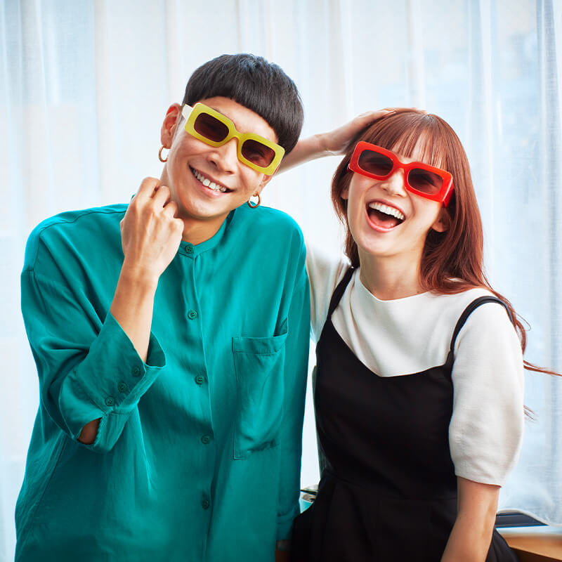 A smiling duo with colorful glasses