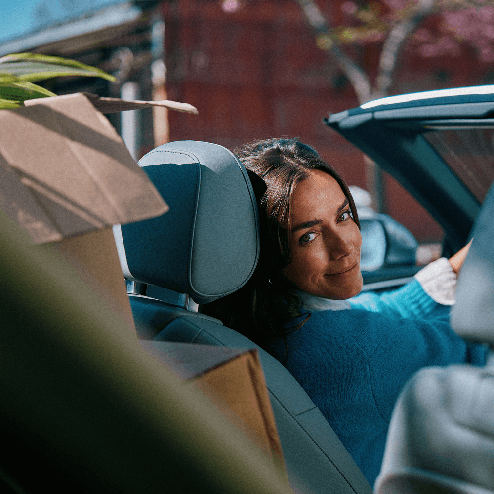 A woman in her car looking behind