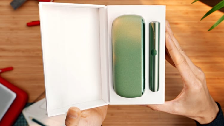 En IQOS ILUMA holder og lommeoplader i æske.