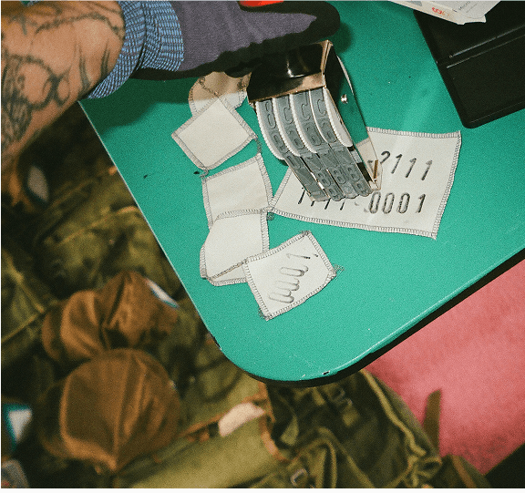 Glove-clad hands numbering materials